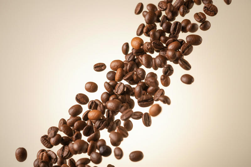 Create a real image of a coffee beans falliing